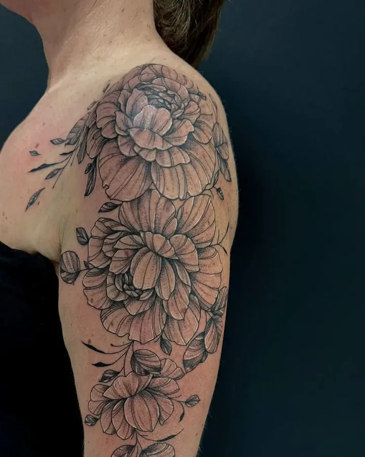 Black linework peony flowers running from shoulder to upper arm